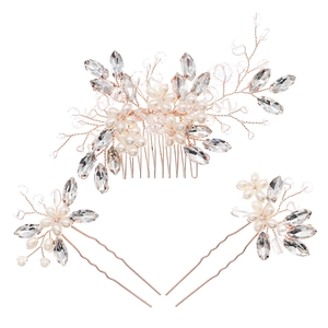 Three-piece bridal hair jewelry set with gold flowers, pearls and crystals on white background