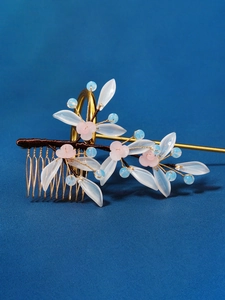 Close-up of traditional Chinese bridal hair comb with pink resin flowers and pearls