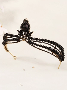 Macro side view of gothic bridal crown with black beads and gold metallic wiring details