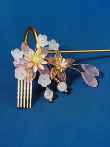 Detail of Chinese hair comb featuring lavender resin flowers and golden beads