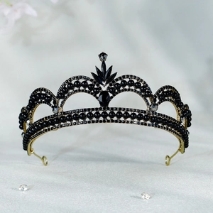 Detail of vintage French bridal crown featuring black rhinestones and gold metal base