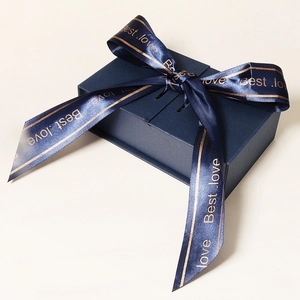 Detail of dark blue gift box with satin ribbon bow and gold Best Love lettering
