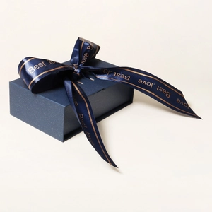 Navy blue matte jewelry gift box with a satin bow featuring golden Best.love text