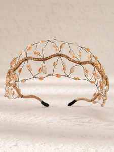 Détail d'un serre-tête baroque fait main avec maille dorée et cristaux orange chaud