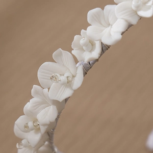 Exquisite bridal headband with handmade white ceramic flowers and clear beads for weddings
