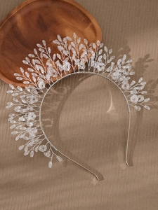 Detail of handmade silver wire bridal headband with clear crystal beads and leaf motifs
