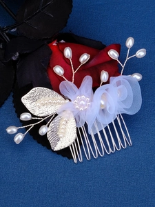 Detail of handcrafted wedding hair comb with white mesh flowers and pearl branches