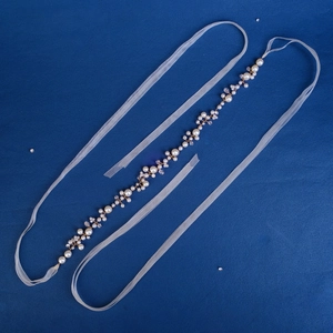 Elegant handmade bridal waist belt featuring white pearls and crystals on white organza ribbon