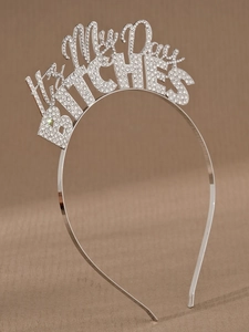 Close-up of sparkling silver rhinestone Birthday BITCHES lettering on a thin metal headband