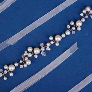 Elegant bridal hair vine with white pearls and crystals on a gold wire base