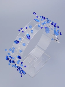 Detail of blue crystal bridal headband with handmade silver wire and beads on acrylic stand