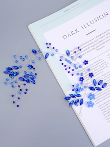 Detail of blue rhinestone bridal headband with handmade beaded crystal leaf design