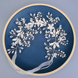 Elegant bridal belt with alloy leaves, pearls, and rhinestones on a blue tray