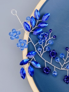 Close-up of blue crystal bridal headband with handcrafted beads and silver wire design