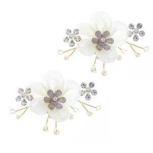 Detail of handmade bridal shoe clips with white petals, pearls and gold wire branches