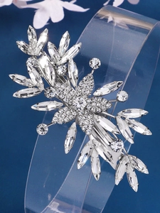 Detail of sparkling rhinestone flower hair clip with silver alloy base and crystal petals