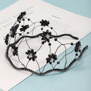 Detail of a vintage black mesh headband featuring crystal flowers and rhinestones