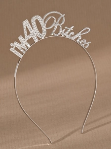 Detailed view of silver rhinestone tiara featuring I'M 40 Bitch text for party decor