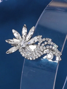 Detailed close-up of a sparkling floral hair clip with clear crystals and rhinestones