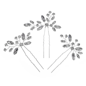 Detail of three handmade silver hair pins with crystal leaf and flower patterns