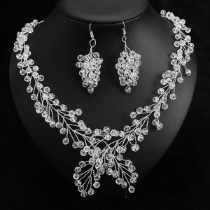 Detailed view of silver crystal bridal vine necklace and earrings on a black bust