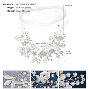 Close-up of bridal sash featuring handmade pearls, rhinestones, and delicate white leaves