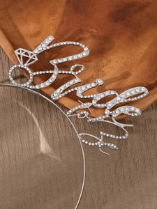 Detailed view of a silver rhinestone Bride headband with diamond ring design