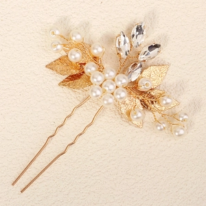 Elegant bridal gold leaf hair pin with white pearls and crystals for wedding hairstyles