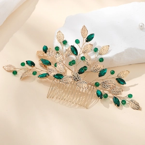 Vintage bridal hair comb with gold leaves and dark green crystals on decorative stones