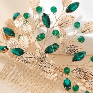 Elegant bridal hair comb with gold leaves and green crystals for wedding hairstyles