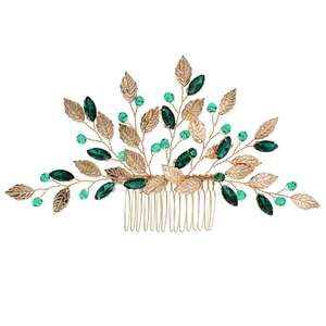 Gold bridal hair comb with elegant metallic leaves and emerald green crystal beads