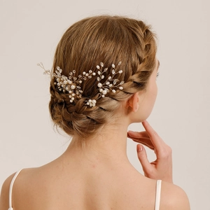 Exquisite bridal hair accessories set with gold wire pearls and rhinestones on model
