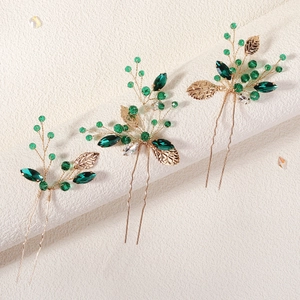 Handmade gold leaf hair pins set with green crystals for bridal wedding hairstyles