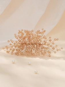 Macro detail of bridal hair comb featuring handmade champagne crystals and gold wiring