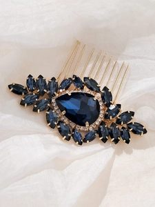 Détail d'un peigne à cheveux de mariage rétro avec cristal bleu foncé et strass dorés