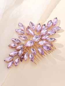 Detail of bridal hair comb with purple marquise rhinestones and gold wire wrapping