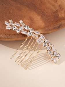 Detail of a 6-tooth golden hair comb with sparkling wave-shaped zircon and rhinestones