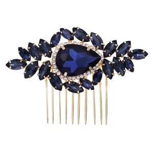 Retro wedding hair comb with deep blue crystals and gold base on white background
