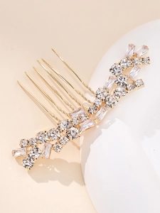 Detailed macro view of bridal gold hair comb featuring rectangular and round zircons