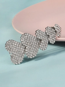 Detail view of sparkling silver alloy hair clip with four rhinestone-encrusted hearts
