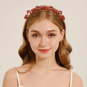Detailed view of red rhinestone hearts on a gold-tone headband for party styling