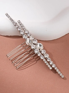 Close-up of silver hair comb featuring intricate pavé-set rhinestones and sparkling gems