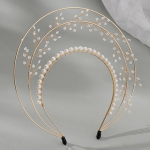Elegant gold bridal headband with layered pearls and handmade metal leaf details