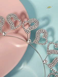 Macro view of silver heart headband with sparkling rhinestones and crystal accents