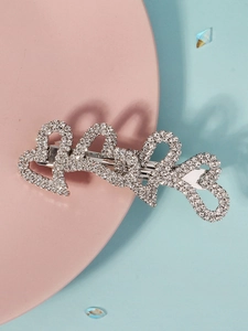 Detailed close-up of interconnected heart hair clip with silver rhinestones on pink and blue