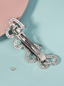 Silver rhinestone hair clip with wave design and spring metal back detail