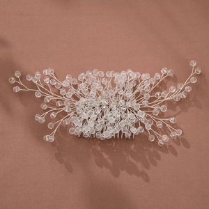 Detailed view of champagne crystal bridal hair comb with silver wire branched structure