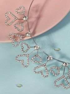 Detail of silver alloy headband with heart镂空patterns and sparkling rhinestones