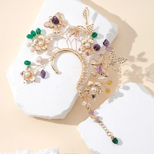Exquisite golden floral butterfly ear wrap with crystals and pearls on white stone