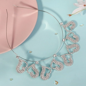 Elegant silver headband with seven sparkling rhinestone heart pendants on a blue background